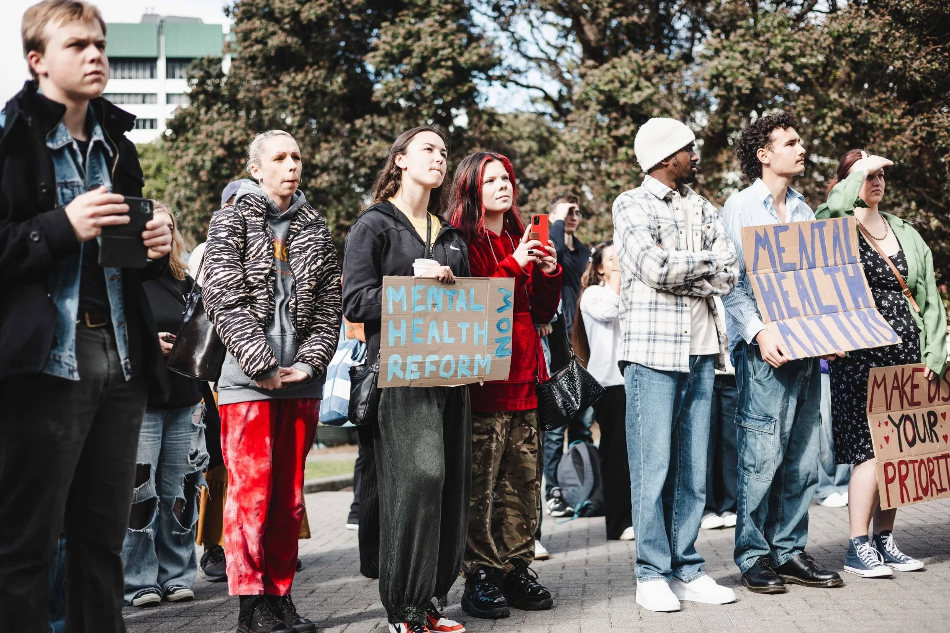 Supporters holding handmade Mental Health Matters placards at a rally